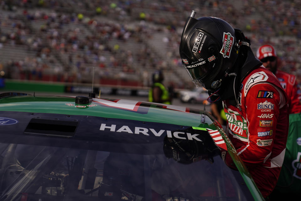 Kevin Harvick (4) gets into his car before a NASCAR Cup Series auto race at Atlanta Motor Speedway on Sunday, July 9, 2023, in Hampton, Ga. (AP Photo/Brynn Anderson)