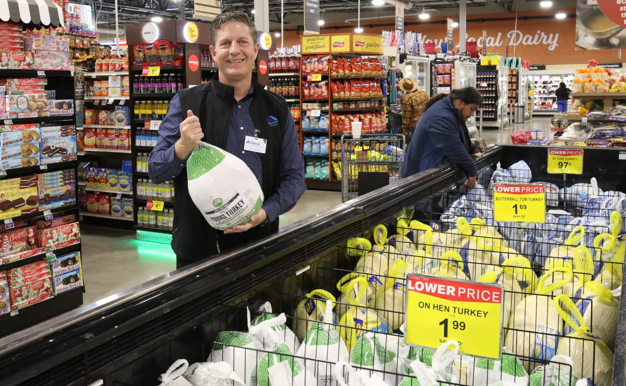 Albertsons Market Store Manager Dave Beaty holds up a Thanksgiving turkey, Nov. 15, 2022 at the store in Carlsbad.