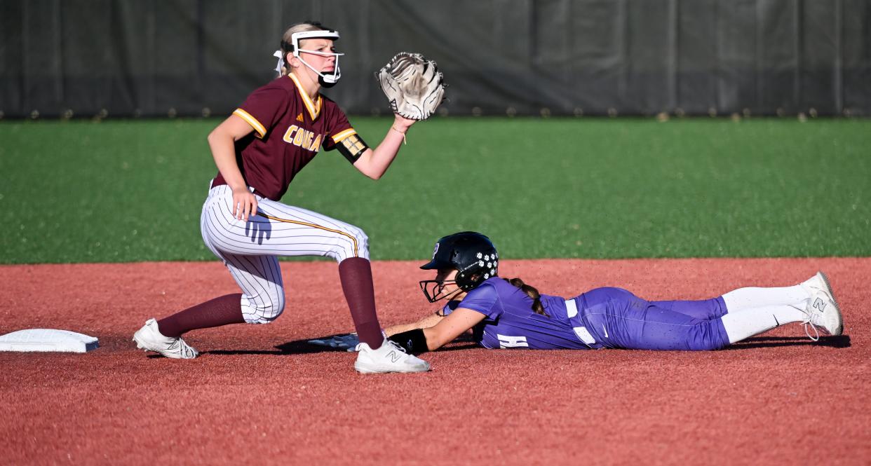 Bloomington South’s Carly Reed steals second base against Bloomington North’s Molly Klein during their softball game at South on Wednesday, April 24, 2024.