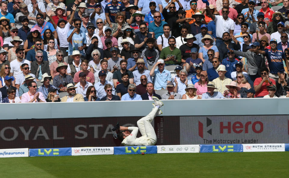 LONDON, ENGLAND - AUGUST 15: England fielder Dom Sibley crashes into the advertising hoarding after attempting to save a boundary during day four of the Second Test Match between England and India at Lord's Cricket Ground on August 15, 2021 in London, England. (Photo by Stu Forster/Getty Images)