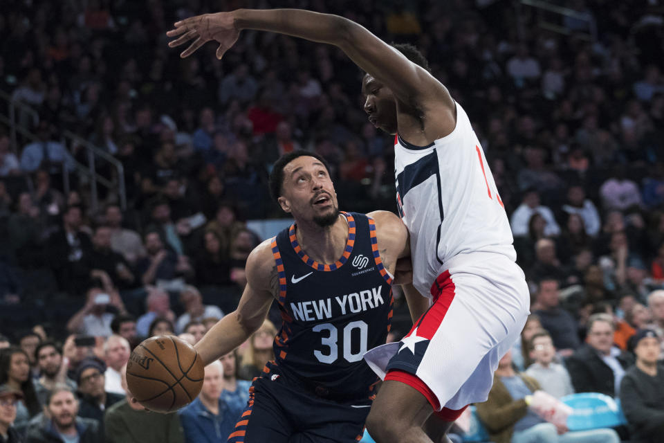 FILE - Washington Wizards center Thomas Bryant guards New York Knicks guard John Jenkins (30) during the second half of an NBA basketball game Sunday, April 7, 2019, at Madison Square Garden in New York. As part of their preparations for big tournaments in recent years, such as the World Cup, which begins on Friday, Aug. 25, 2023 in the Philippines, Indonesia and Japan — USA Basketball has been taking a few extra players to help in practices and workouts. Jenkins, Langston Galloway and Eric Mika were the trio that got the call for this trip. (AP Photo/Mary Altaffer, File)