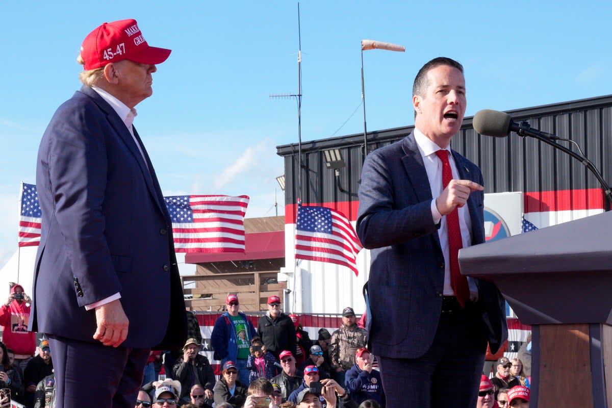 Donald Trump looks on as his favoured candidate for the US Senate, Bernie Moreno, speaks at a rally in Dayton  (AP)