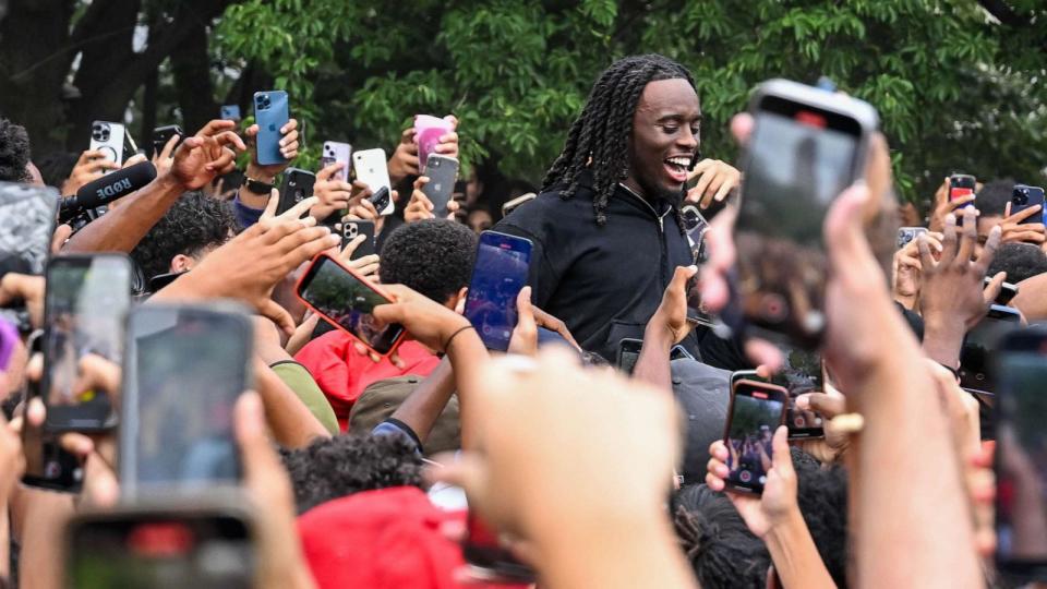 PHOTO: People gather around and cheer for Kai Cenat as members of the NYPD respond to thousands of people gathered for a 'giveaway' event announced by popular Twitch live streamer Kai Cenat in Union Square and the surrounding area, Aug. 4, 2023 in NYC. (Alexi J. Rosenfeld/Getty Images)