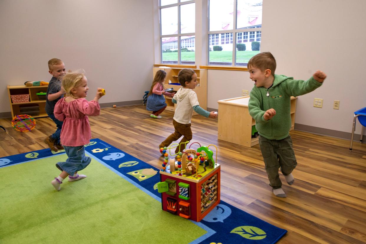Children play a classroom of the new McKenzie Little Eagles Childcare Center during an open house March 23 in Blue River.