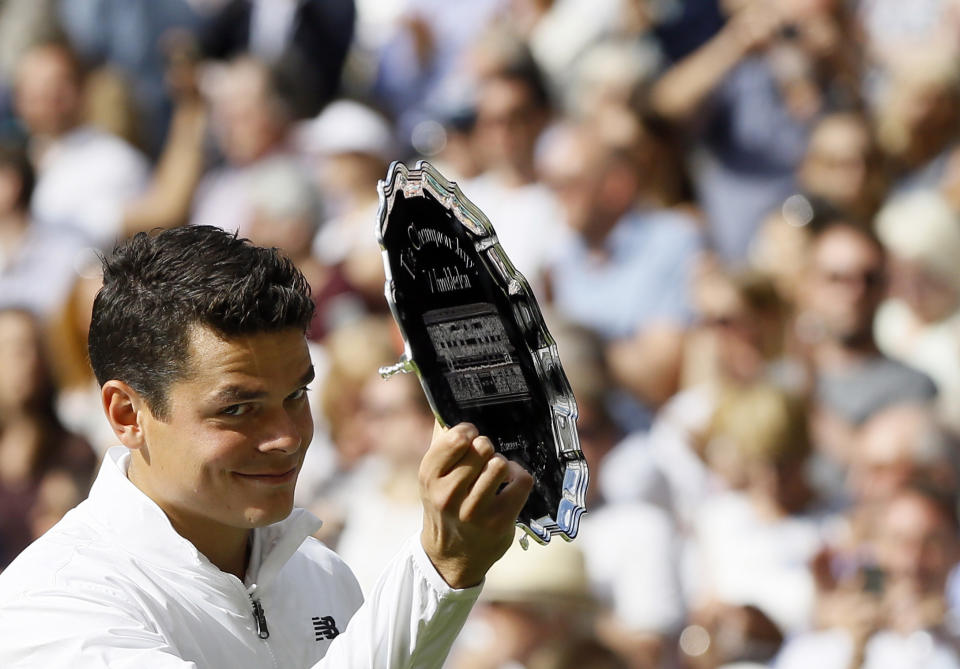 FILE - Milos Raonic, of Canada, holds his runner's up trophy after being beaten by Andy Murray, of Britain, in the men's singles final on the fourteenth day of the Wimbledon Tennis Championships in London, July 10, 2016. Raonic is one of several players who recently returned to the tennis tour after time away, helping make this the year of comebacks at the 2023 U.S. Open, which was scheduled to begin in New York on Monday, Aug, 28, 2023. (AP Photo/Kirsty Wigglesworth, File)