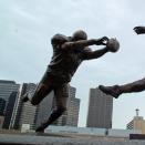 This photo released July 27, 2012 by the New Orleans Saints shows the blocked punt that etched Steve Gleason into New Orleans Saints lore, and the symbolic significance that play took on in a city just starting to recover from disaster, is now immortalized in a nine-foot statue outside the Superdome. Gleason, who now has ALS, famously blocked the ball off of the foot of then-Atlanta punter Michael Koenen and into the end zone for a Saints touchdown on Sept. 25, 2006, the night the rebuilt Superdome and the city of New Orleans hosted an NFL game for the first time since Hurrciane Katrina. The statue, entitled "Rebirth," depicts Gleason fully outstretched in a dive, his hands smothering the ball as it leaves Koenen's foot. Gleason says the statue is symbolizes the commitment of those who returned to rebuild after the storm. (AP Photo/New Orleans Saints, Alex Restrepo)