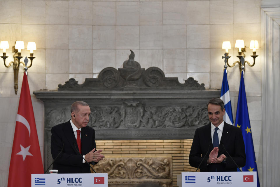 Greece's Prime Minister Kyriakos Mitsotakis, right, and Turkey's President Recep Tayyip Erdogan applaud after their statements at Maximos Mansion in Athens, Greece, Thursday, Dec. 7, 2023. Turkish President Recep Tayyip Erdogan is visiting Greece in an effort to mend strained relations and reset ties with Western allies. (AP Photo/Michael Varaklas)