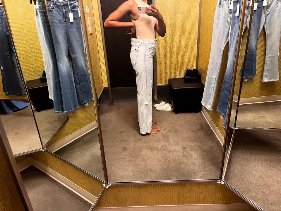 Author Joi-Marie McKenzie trying on jeans in a Nordstrom dressing room.