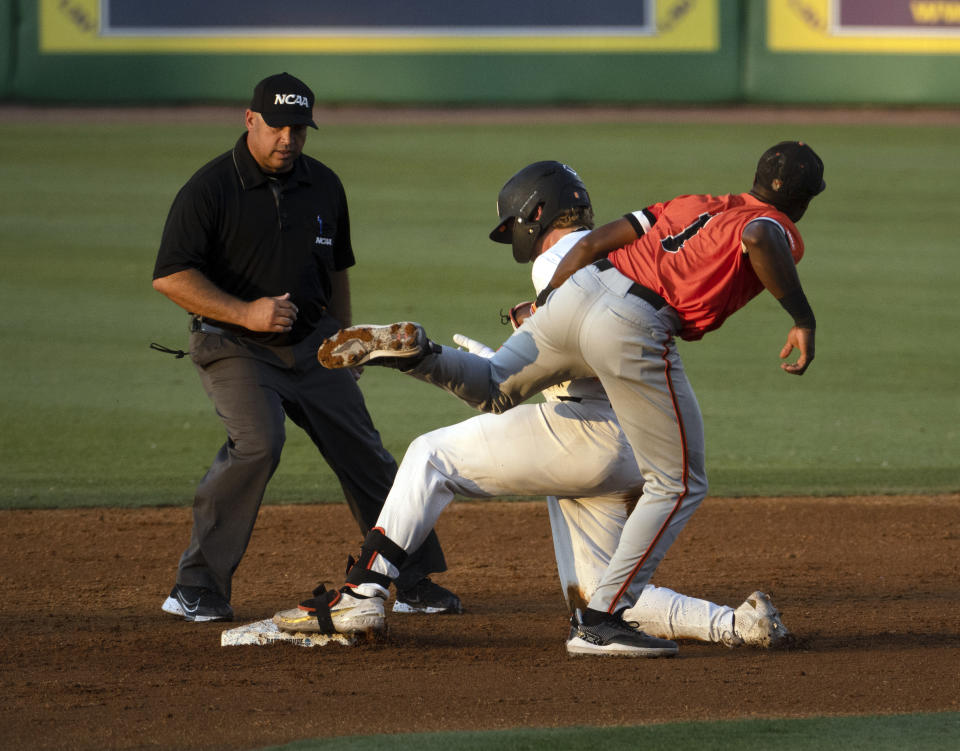 Oregon State's Tanner Smith, center, and Sam Houston State shortstop Myles Jefferson (1) collide on a play as Smith is tagged out at second base by Jefferson in an NCAA college baseball tournament regional game Friday, June 2, 2023, in Baton Rouge, La. (Hilary Scheinuk/The Advocate via AP)