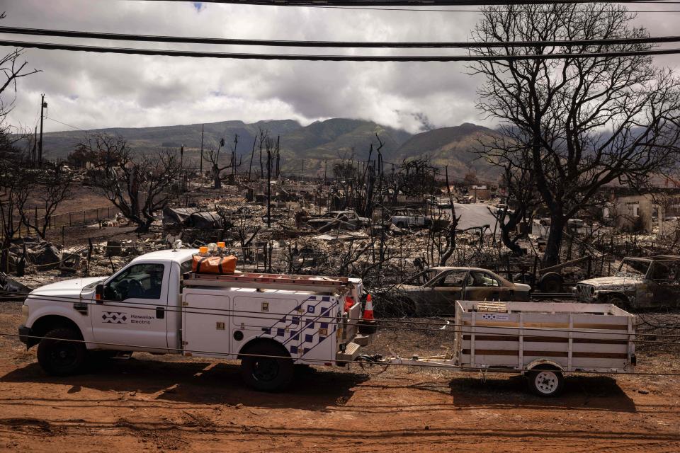 A Hawaiian Electric truck is pictured near a destroyed neighbourhood in the aftermath of the Maui wildfires in Lahaina, Hawaii on August 16, 2023.