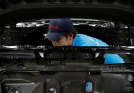 An employee of Toyota Motor Corp. works on the assembly line of Mirai fuel cell vehicle (FCV) at the company's Motomachi plant in Toyota, Aichi prefecture, Japan, May 17, 2018. Picture taken May 17, 2018. REUTERS/Issei Kato