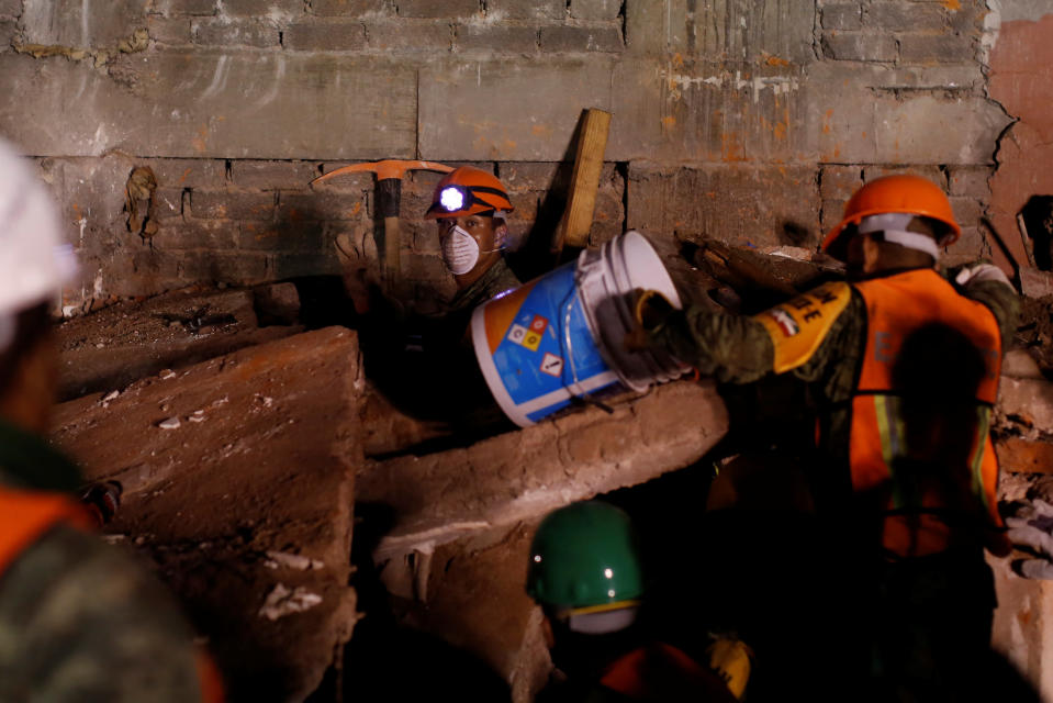 <p>Mexican soldiers search for survivors in a collapsed building after an earthquake at Condesa neighborhood in Mexico City, Mexico, September 21, 2017. REUTERS/Carlos Jasso </p>