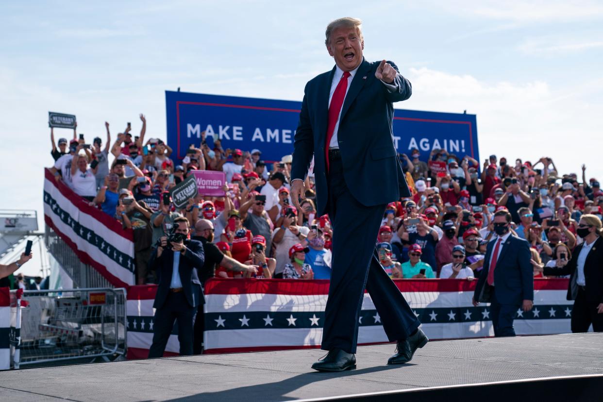 President Donald Trump arrives to speak to a campaign rally at Ocala International Airport.