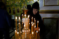 A nun attends a mass at Kyiv Pechersk Lavra Monastery in Kyiv, Ukraine, Saturday, May 28, 2022. The leaders of the Orthodox churches in Ukraine that were affiliated with the Russian Orthodox Church have announced on a statement they will sever ties with Russia over its invasion of Ukraine. (AP Photo/Natacha Pisarenko)