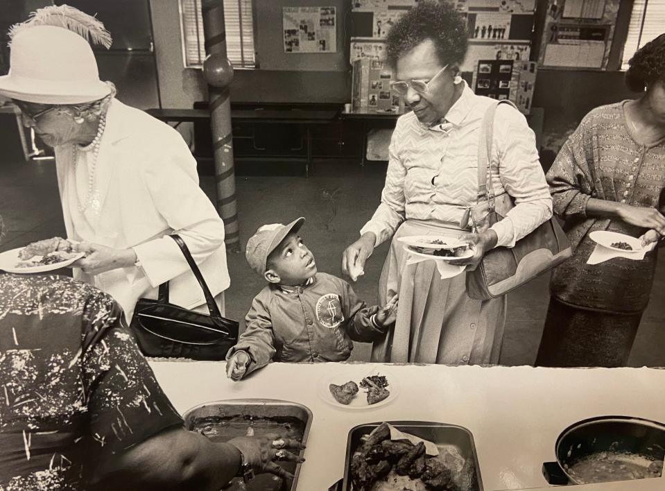 Keyon Bush, 5, and his grandmother Erline Menefee get lunch in February 1988 at the International Black Food Festival at Second Baptist Church. The festival marked the end of a month's worth of activities at the church during Black History Month.