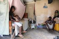 A family is pictured inside their home in Bainet