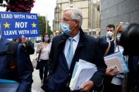 FILE PHOTO: EU's Chief Negotiator Michel Barnier walks with an entourage to a meeting in Westminster