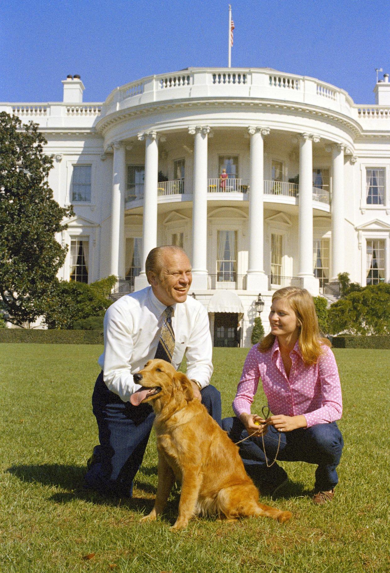 In this Oct. 7, 1974, file photo President Gerald Ford and his daughter, Susan, are seen on the South Lawn of the White House with their dog, Liberty, in Washington. The arrival of the Biden pets will also mark the next chapter in a long history of pets residing at the White House after a four-year hiatus during the Trump administration. (AP Photo, File)