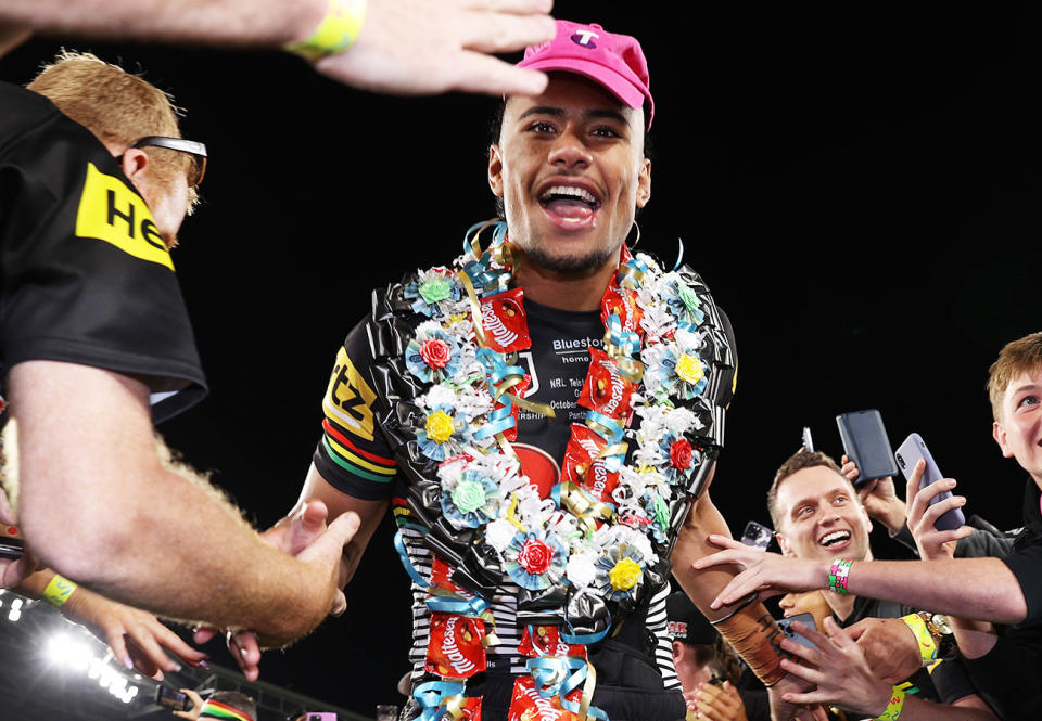 Stephen Crichton, pictured here wearing the pink Telstra hat as he makes his way onto the stage.