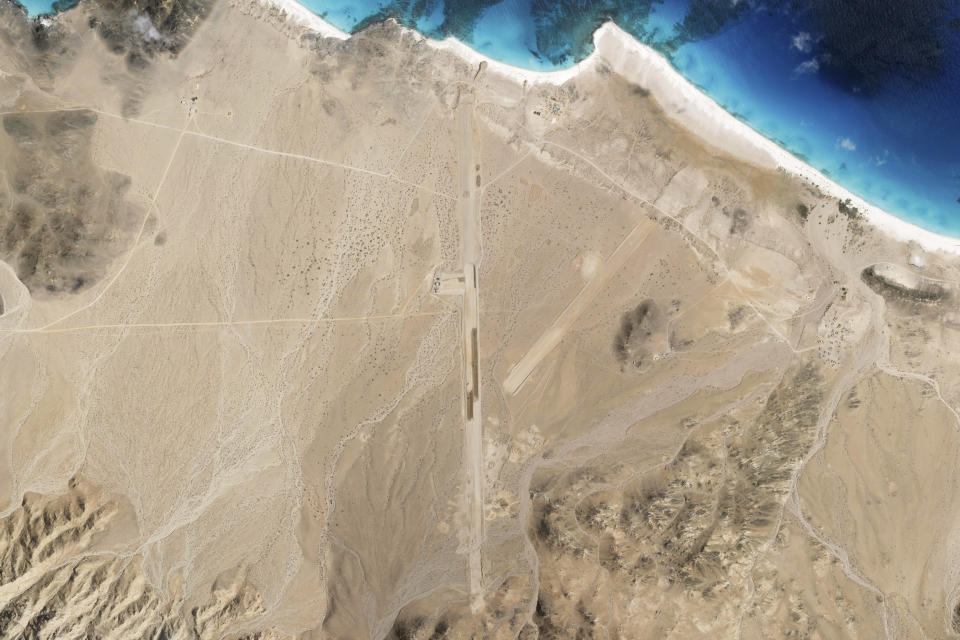 This satellite photo captured by Planet Labs PBC shows the construction of an airstrip on Abd al-Kuri Island, Yemen, March 11, 2024. As Yemen's Houthi rebels continue to target ships in a vital Mideast waterway, satellite pictures analyzed by The Associated Press show what appears to be a new airstrip being built at an entrance to that crucial maritime route. No country has claimed publicly the active construction taking place this month on Abd al-Kuri Island, a barren stretch of land rising out of the Indian Ocean near the mouth of the Gulf of Aden. However, satellite images shot for the AP appear to show workers have laid out "I LOVE UAE" next to the runway, an abbreviation for the United Arab Emirates. (Planet Labs PBC via AP)