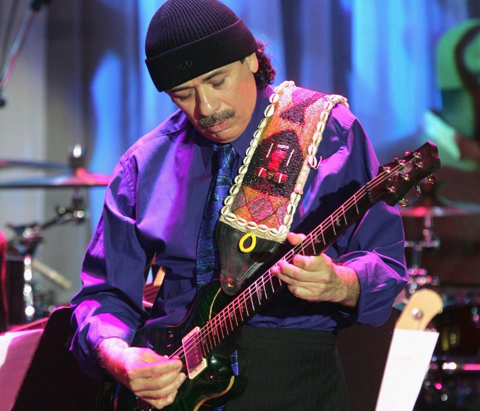 In this 2005 performance photo, Carlos Santana dives into yet another solo. The musician grew up in Mexico and found fame as a 22-year-old at Woodstock. His story is the subject of a new documentary, "Carlos."