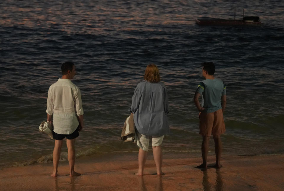 jeremy strong, sarah snook, and kieran culkin standing on a beach in a scene from succession