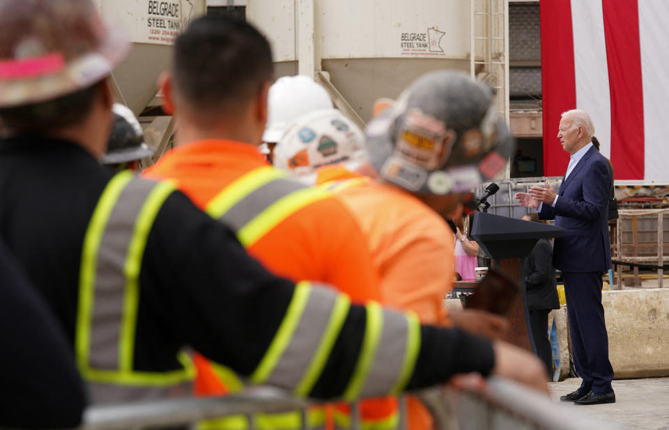 Construction workers listen as U.S. President Joe Biden speaks about investments in infrastructure during a visit to the LA Metro, D Line (Purple) Extension Transit Project in Los Angeles, California, U.S., October 13, 2022.  REUTERS/Kevin Lamarque