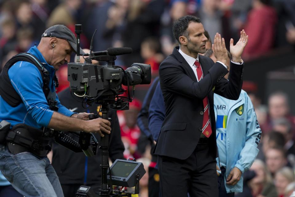 Manchester United's interim manager Ryan Giggs applauds supporters after his team's 4-0 win against Norwich City in their English Premier League soccer match at Old Trafford Stadium, Manchester, England, Saturday April 26, 2014. (AP Photo/Jon Super)