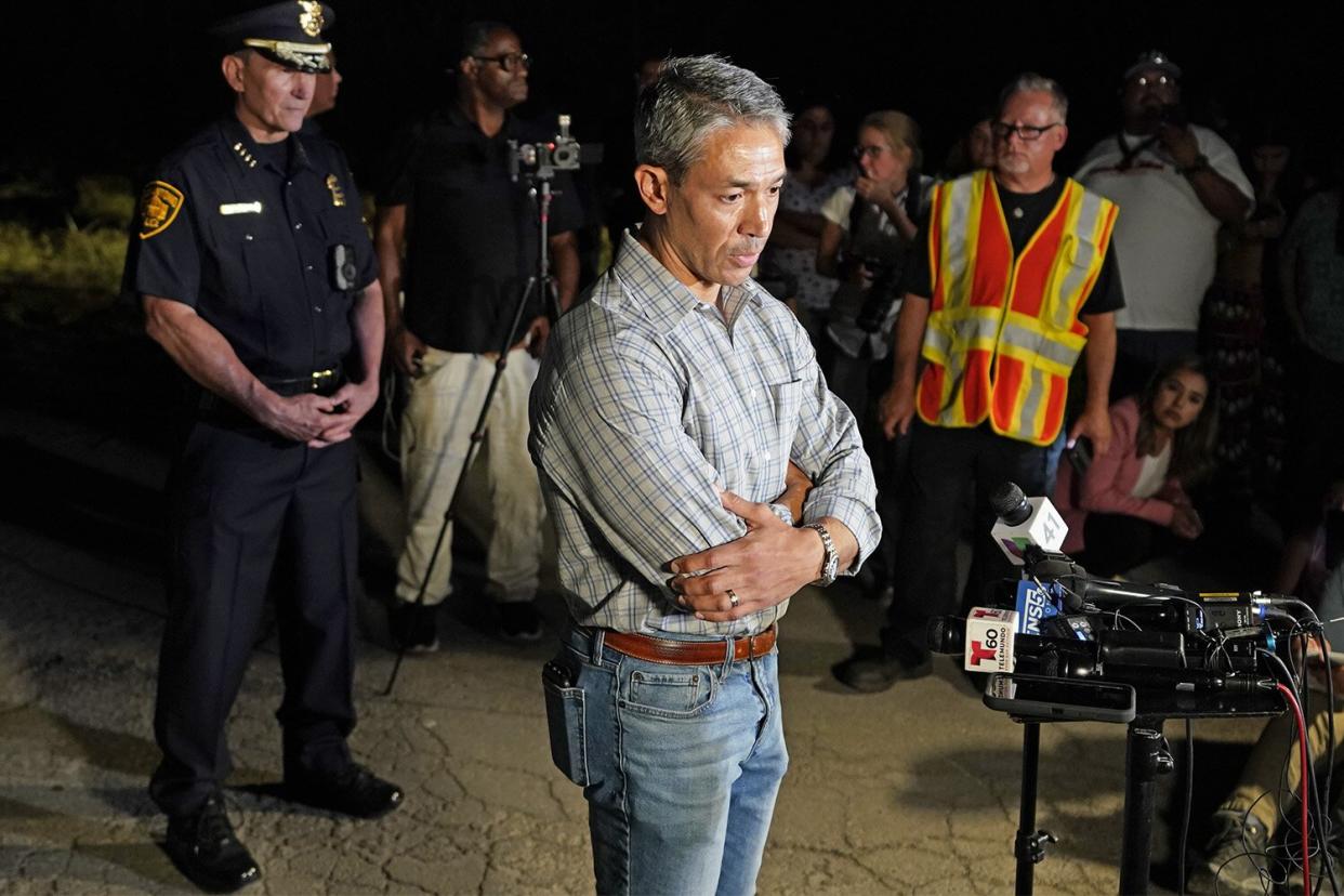 Mandatory Credit: Photo by Eric Gay/AP/Shutterstock (13008136h) San Antonio Mayor Ron Nirenberg, center, with San Antonio Police Chief William McManus, left, brief media and others at the scene where they said dozens of people have been found dead and multiple others were taken to hospitals with heat-related illnesses after a semitrailer containing suspected migrants was found, in San Antonio Migrant Deaths, San Antonio, United States - 27 Jun 2022