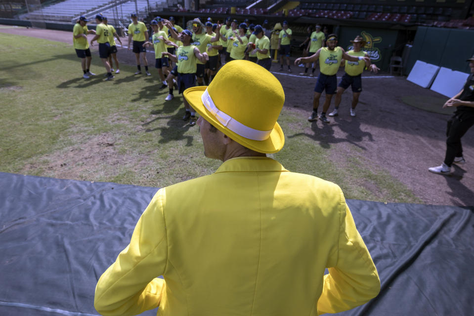 Savannah Bananas owner Jesse Cole watches a rehearsal before the team's game against the Florence Flamingos in the Coastal Plain League collegiate summer baseball league Tuesday, June 7, 2022, in Savannah, Ga. (AP Photo/Stephen B. Morton)