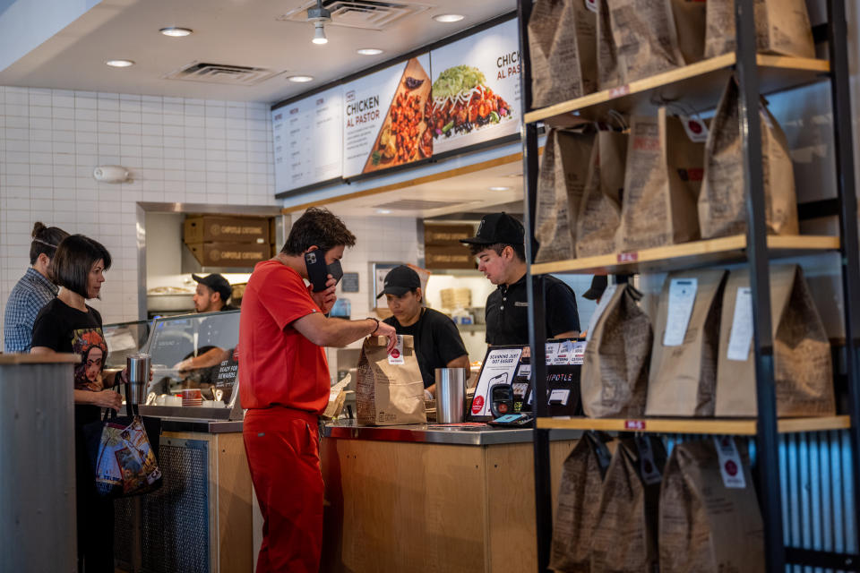 AUSTIN, TEXAS - APRIL 26: Customers order food at a Chipotle Mexican Grill restaurant on April 26, 2023 in Austin, Texas. Chipotle Mexican Grill posted strong quarterly earnings. Chipotle shares climbed as same-store sales rose 10.9%. (Photo by Brandon Bell/Getty Images)