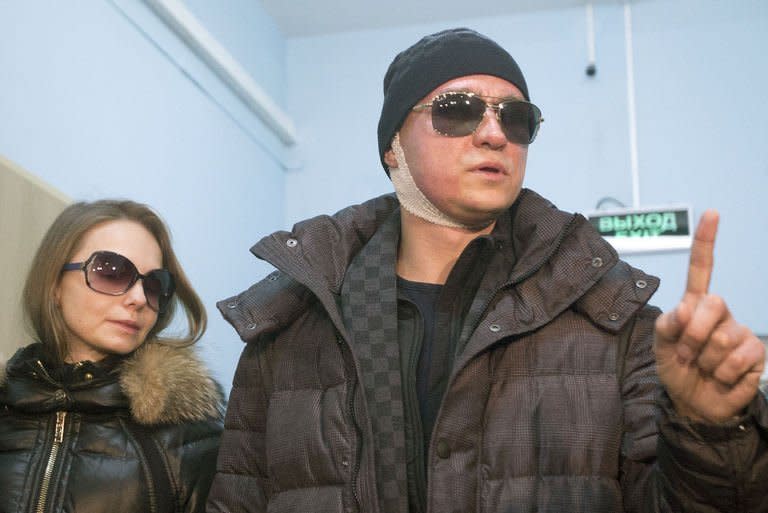 The Bolshoi Ballet's artistic director Sergei Filin leaves hospital accompanied by his wife Maria (L) in Moscow, on February 4, 2013. Filin has left Russia for Germany in the hope of recovering his eyesight after an acid attack, claiming he knew the mastermind behind the gruesome assault