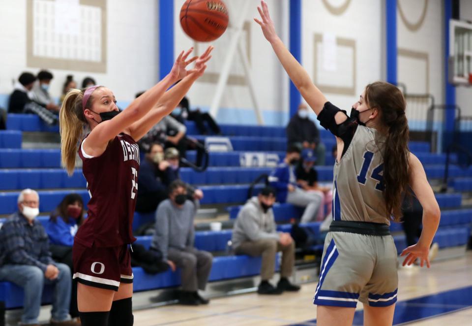 Ossining's Ella Schnecker (22 ) puts up a 3-point shot in front of Port Chester's Madison Ostrowski (14) during girls basketball action at Port Chester High School Jan. 13, 2022. Ossining won the game.