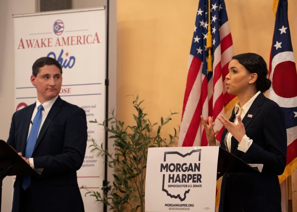 Democratic candidate Morgan Harper, right, speaks while being watches by Republican candidate Josh Mandel during an Ohio Senate debate at North Columbus Baptist Church in Columbus, Ohio, on Thursday, Jan. 27, 2022.  