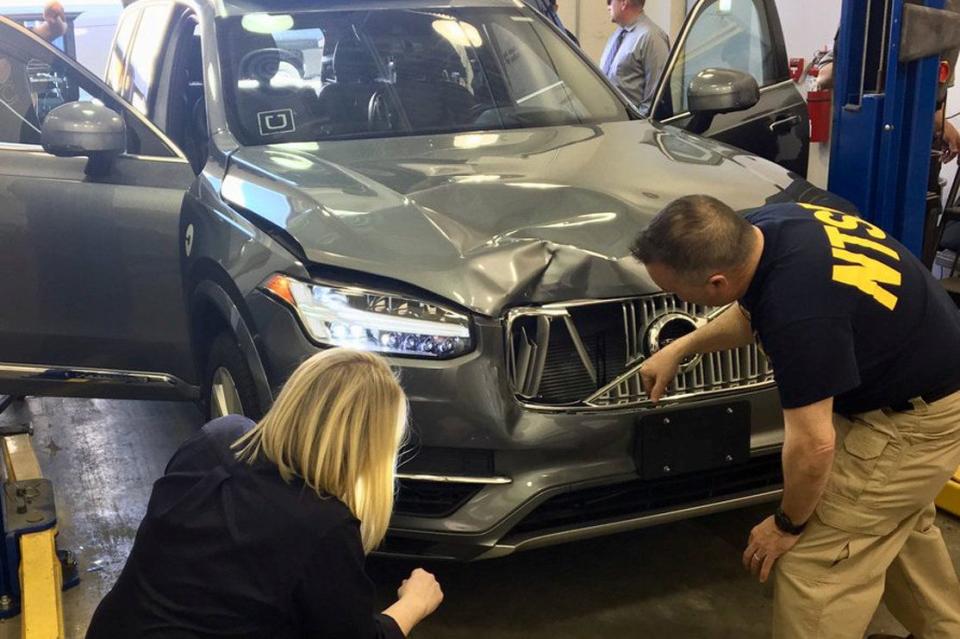 National Transportation Safety Board investigators examine the self-driving Uber vehicle involved in the fatal accident. (Photo: Handout . / Reuters)