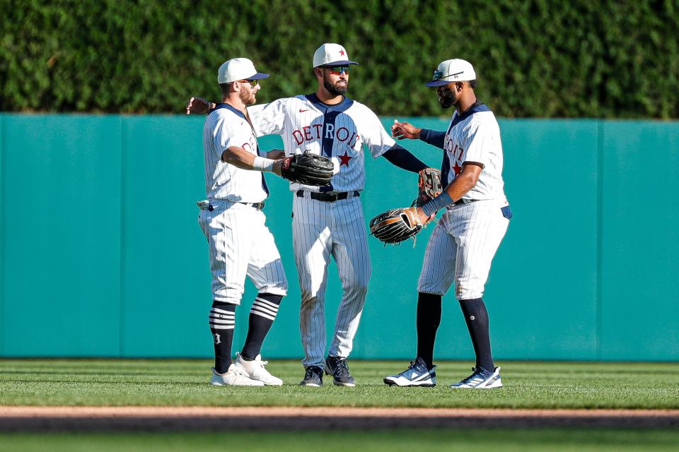 Detroit Tigers center fielder Riley Greene (31), center, is congratulated by left fielder Robbie Grossman (8) and right fielder Willi Castro (9) after the Tigers won 14-7 over Texas Rangers at the Comerica Park in Detroit on Saturday, June 18, 2022.