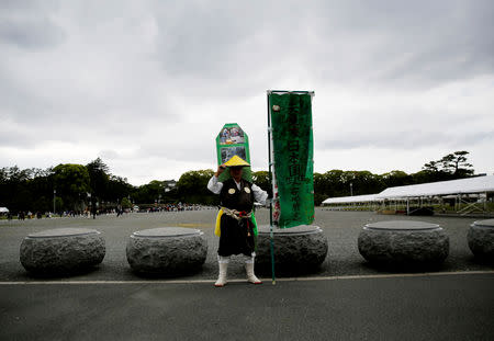 Korean resident in Japan, Kim Fuzan in traditional pilgrim attire wishes a successful abdication for the emperor in front of the Imperial Palace in Tokyo, Japan, April 29, 2019. REUTERS/Kim Kyung-hoon