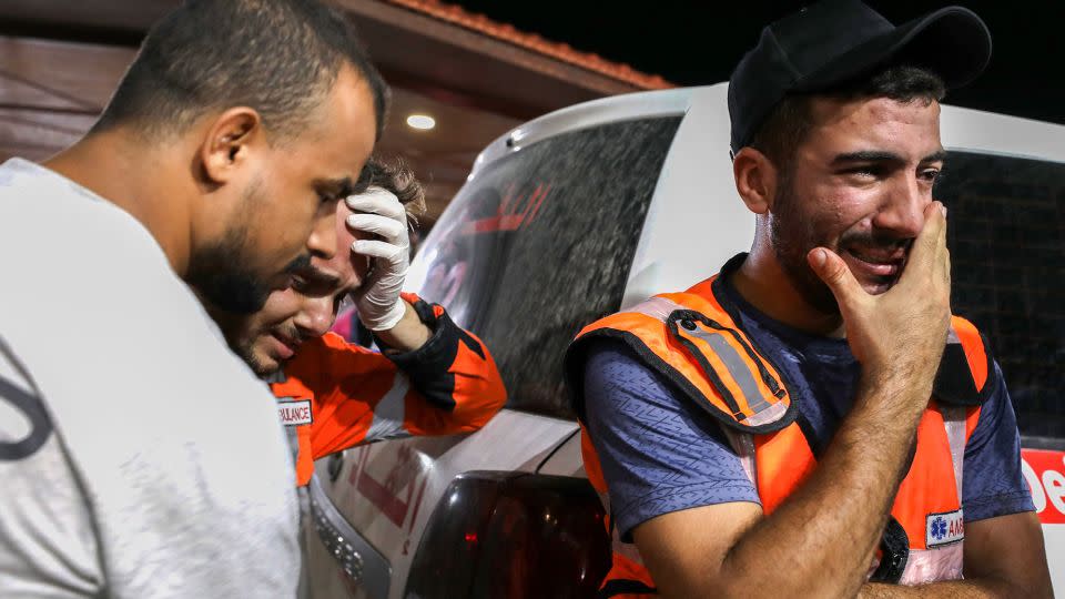 Palestinian paramedics cry outside al-Shifa hopsital, in Gaza City, on Monday. Humanitarian groups say the Israeli blockade and airstrikes on the Palestinian enclave are in violation of international law.  - Dawood Nemer/AFP/Getty Images