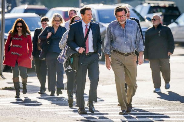 PHOTO: Lead attorney for the plaintiffs, Chirs Mattie (center) walks with families of Sandy Hook shooting victims and other lawyers as they arrive at the Connecticut Superior Court, in Waterbury, Conn, Oct. 12, 2022. (Bryan Woolston/AP)