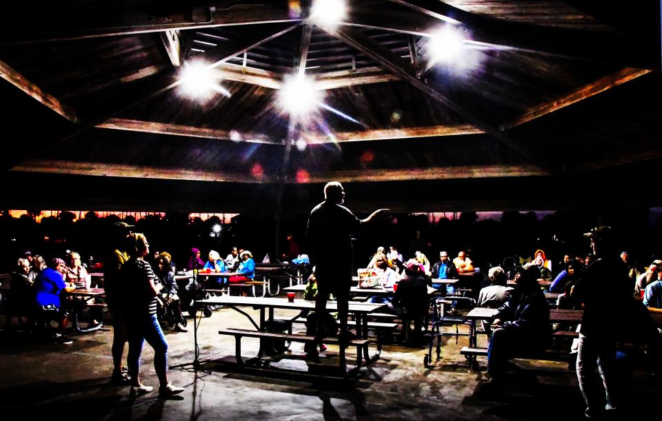 Mike Waugh, a parishioner at St. Teresa Catholic Church, makes announcements before a meal is served for anyone in need by the Under the Bridge ministry in Titusville. Waugh has been part of the ministry for eight years: It does more for him, he said, than he does for it.