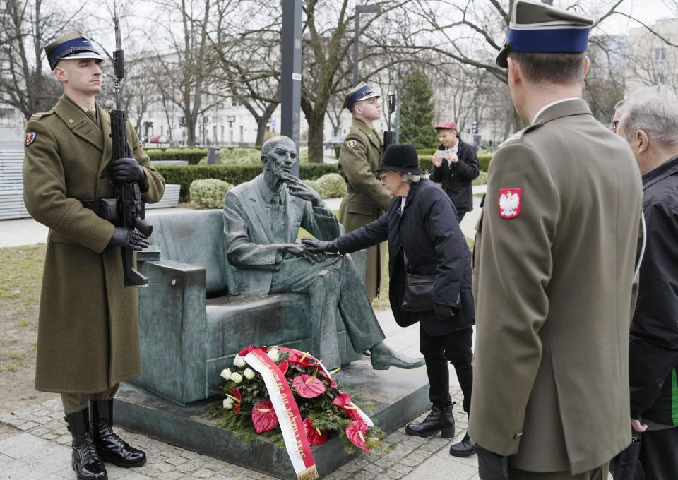 Members of a foundation supporting Poles who saved Jews from the Holocaust honour resistance emissary Jan Karski, who informed western leaders about mass killings of Jews by Nazi Germans, during national day of remembrance of Poles who risked their lives to save Jews, in Warsaw, Poland, on Friday, March 24, 2023. The solemn meetings, wreath laying and prayers Friday were held 79 years after the entire Ulma family were shot dead along with eight Jews whom their were hiding in their farm. (AP Photo/Czarek Sokolowski)