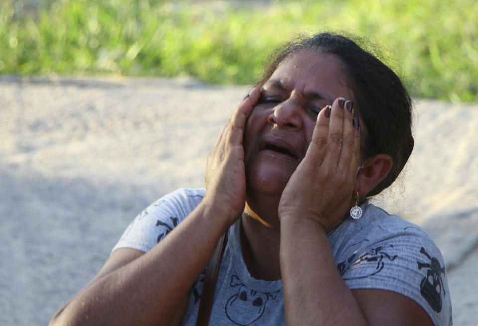 The mother of a prisoner cries outside the Anisio Jobim Prison Complex in Manaus, Amazonas state, Brazil, Monday, May 27, 2019. Brazilian authorities said 42 inmates were killed at three different prisons in the capital of the northern state of Amazonas, a day after 15 prisoners died in a riot at a fourth prison in the city. (AP Photo/Edmar Barros)