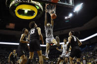 Oregon center Kel'el Ware (10) dunks over Colorado players during the first half of an NCAA college basketball game Thursday, Jan. 26, 2023, in Eugene, Ore. (AP Photo/Andy Nelson)