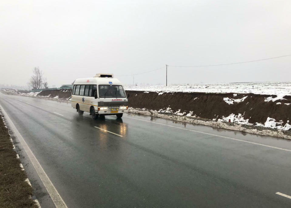 An ambulance drives on a highway, traveling from the direction of a large explosion, in Pampore, Indian-controlled Kashmir, Thursday, Feb. 14, 2019. Security officials say at least 10 soldiers have been killed and 20 others wounded by a large explosion that struck a paramilitary convoy on a key highway on the outskirts of the disputed region's main city of Srinagar. (AP Photo/Dar Yasin)