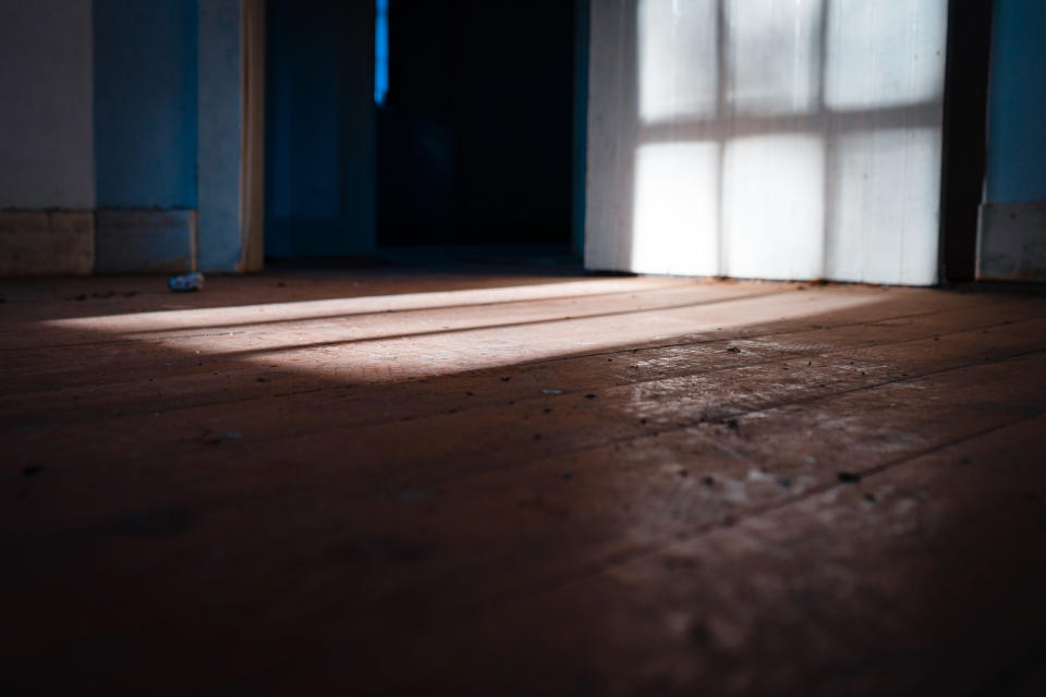 Light shining through a window into an empty room.