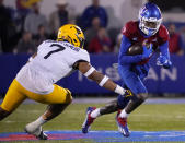 Kansas wide receiver Steven McBride (19) runs against West Virginia linebacker Josh Chandler-Semedo (7) during the first quarter of an NCAA college football game Saturday, Nov. 27, 2021, in Lawrence, Kan. (AP Photo/Ed Zurga)