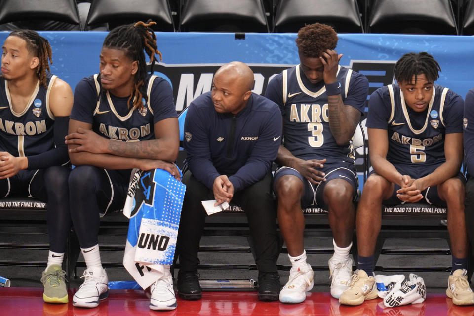 The Akron bench watches the final minutes of a 77-60 loss to Creighton in a college basketball game in the first round of the NCAA men’s tournament in Pittsburgh, Thursday, March 21, 2024. (AP Photo/Gene J. Puskar)