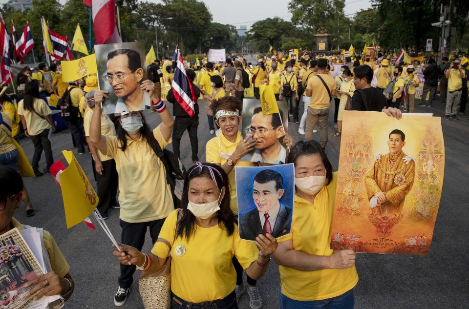 Supporters of the Thai monarchy display images of King Maha Vajiralongkorn and the late King Bhumibol Adulyadej during a rally at Lumphini park in central Bangkok, Thailand Tuesday, Oct. 27, 2020. Hundreds of royalists gathered to oppose pro-democracy protesters' demands that the prime minister resign, constitution be revised and the monarchy be reformed in accordance with democratic principles. (AP Photo/Gemunu Amarasinghe)