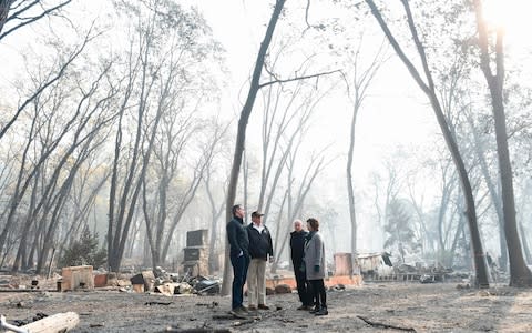  US President Donald Trump (2L) looks on with Paradise Mayor Jody Jones (R), Governor of California Jerry Brown (2R), and Lieutenant Governor of California, Gavin Newsom - Credit: AFP