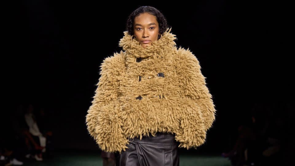 High-collared shearling jackets were finished with horsebit buckles and hardware. - Burberry